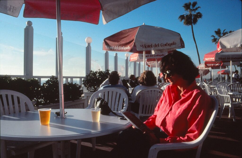 My indulgent friend enjoys a drink and great weather outside the Hotel del Coronado in San Diego.
