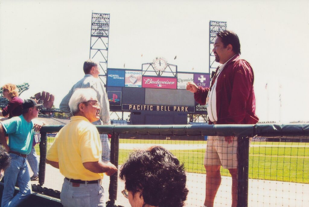 Steven Yung, right, who like the Giants came here from New York, conducts a tour of Pac Bell Park.