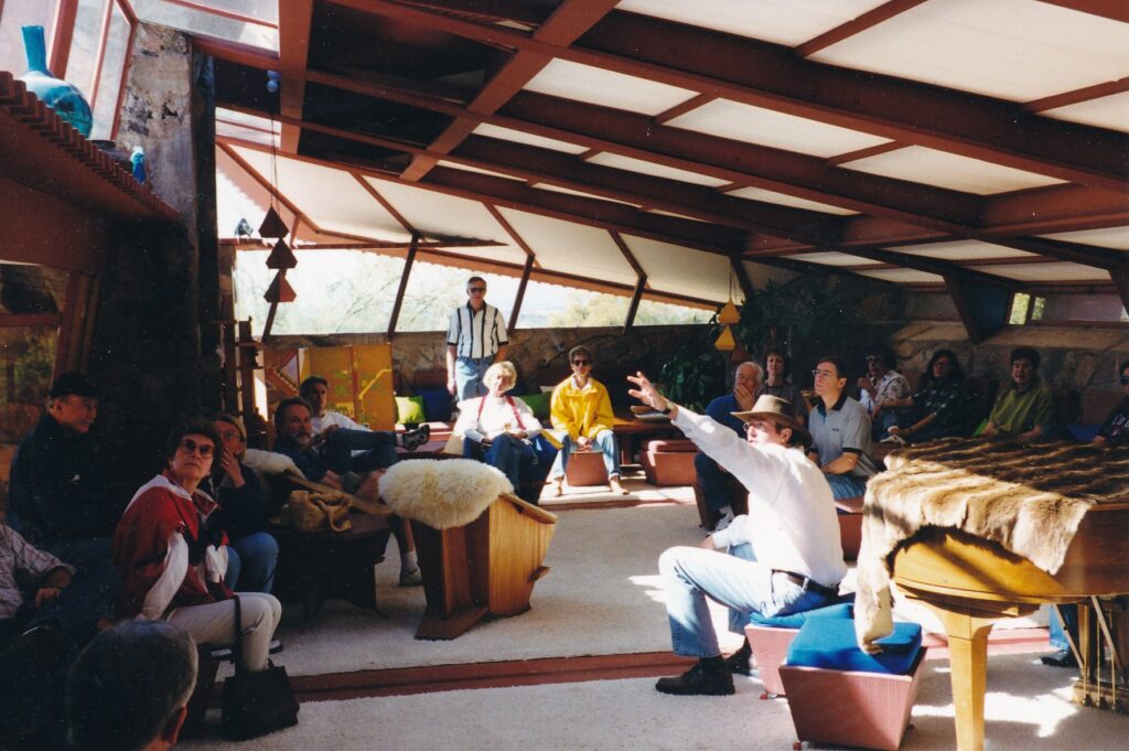 In Frank Lloyd Wright's living room, Taliesen West tour guide Eric Flesch points out how the sloping ceiling gently dictates separate areas for sitting (where the ceiling is lower) and standing. 